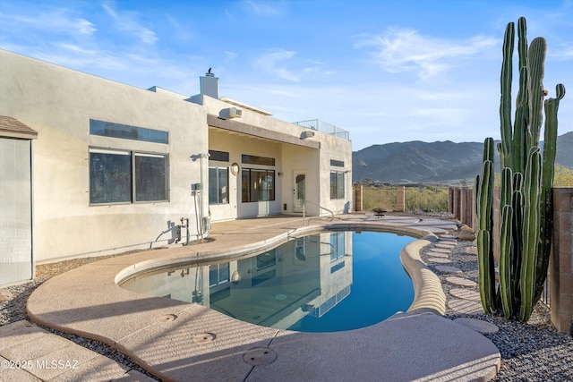 view of swimming pool featuring a mountain view and a patio