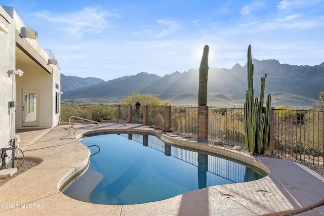 view of pool with a mountain view and a patio