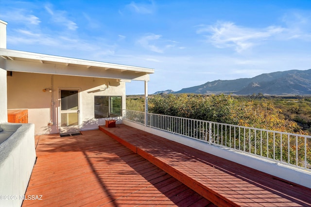 wooden deck with a mountain view