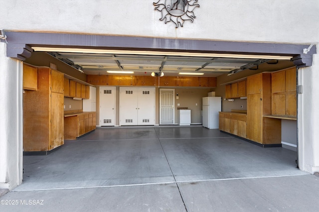 garage featuring white fridge