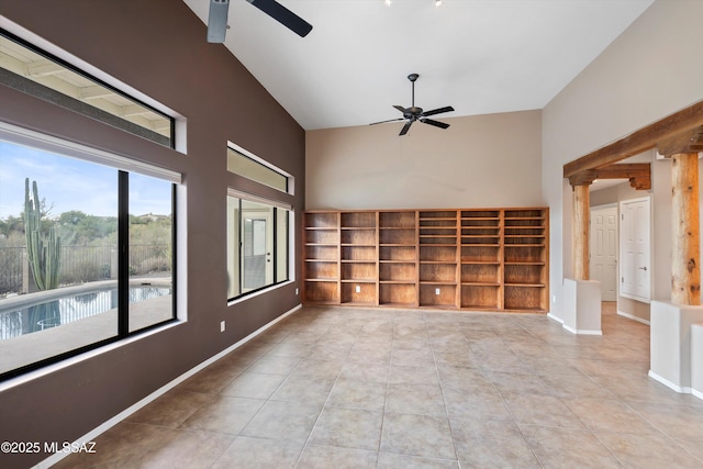 spare room with ornate columns, ceiling fan, high vaulted ceiling, and light tile patterned flooring