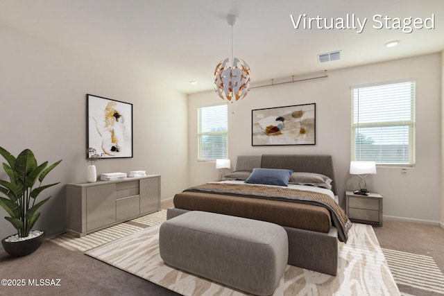 bedroom featuring a notable chandelier, baseboards, visible vents, and carpet floors