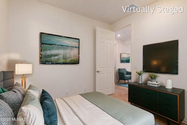 bedroom with wood finished floors