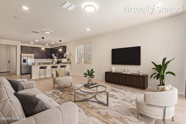 living room featuring recessed lighting, visible vents, light carpet, and baseboards