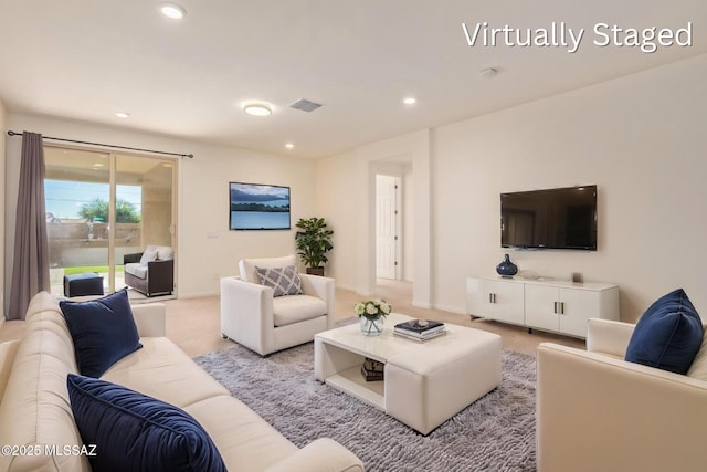 living area featuring recessed lighting and visible vents