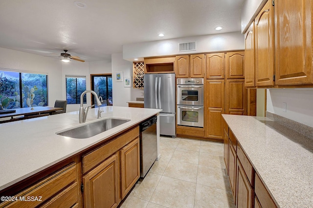 kitchen featuring ceiling fan, light tile patterned floors, sink, and stainless steel appliances