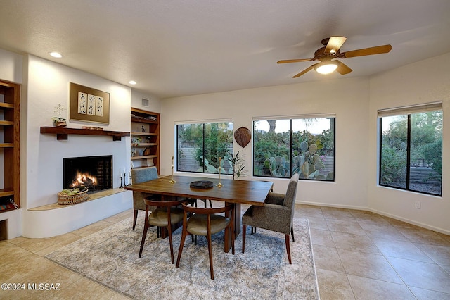 dining area with light tile patterned floors, built in features, and ceiling fan