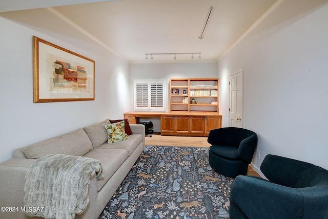 living room with hardwood / wood-style flooring, rail lighting, and ornamental molding