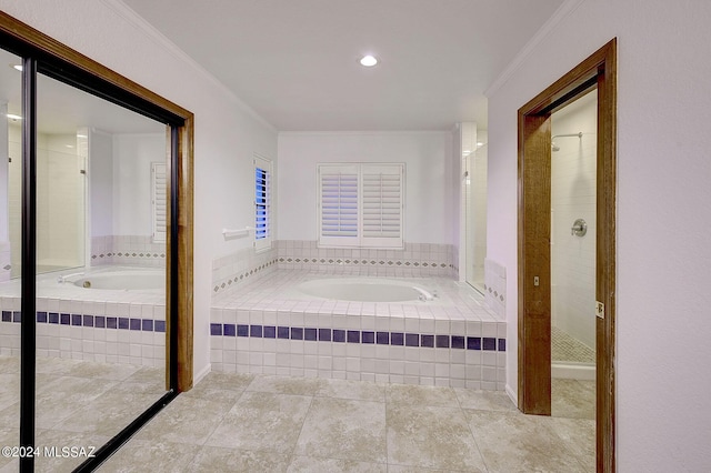 bathroom featuring ornamental molding and shower with separate bathtub