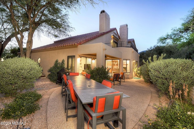 back of property with a balcony