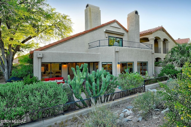 back of property with a balcony