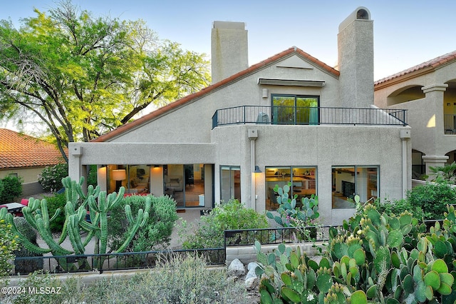 rear view of property featuring a balcony