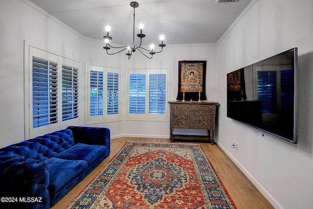 living room featuring hardwood / wood-style flooring, a chandelier, and ornamental molding