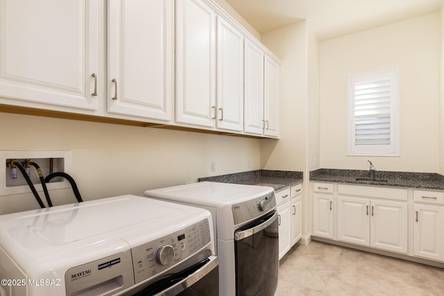 laundry room featuring cabinets, washer and dryer, and sink