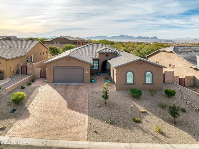 view of front of home featuring a mountain view and a garage