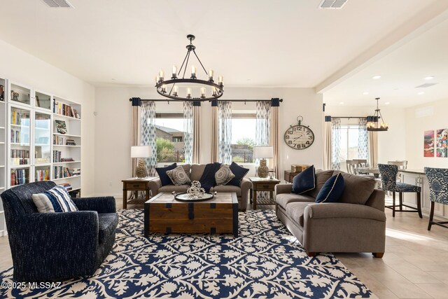 tiled living room featuring an inviting chandelier