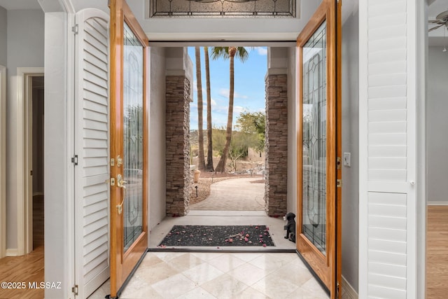 foyer with french doors and light tile patterned floors