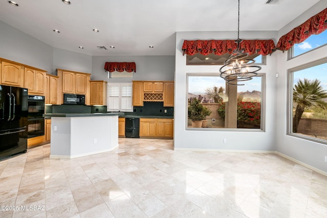 kitchen featuring black appliances, a healthy amount of sunlight, backsplash, and an inviting chandelier