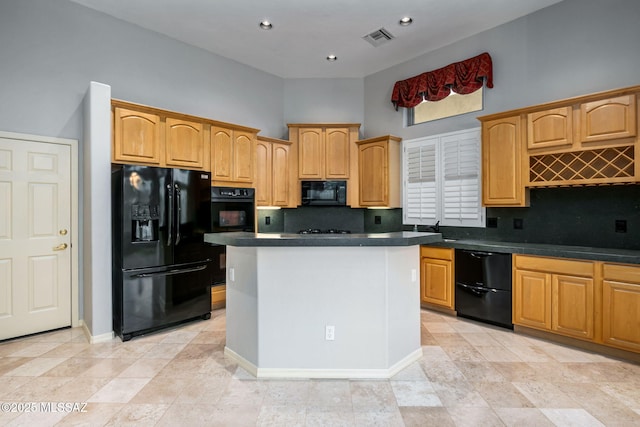 kitchen featuring decorative backsplash, a towering ceiling, a kitchen island, and black appliances