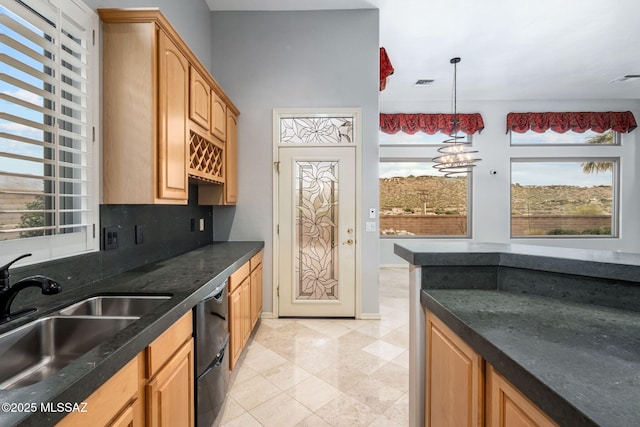 kitchen with dishwasher, pendant lighting, an inviting chandelier, and sink