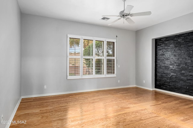 spare room with ceiling fan and hardwood / wood-style floors