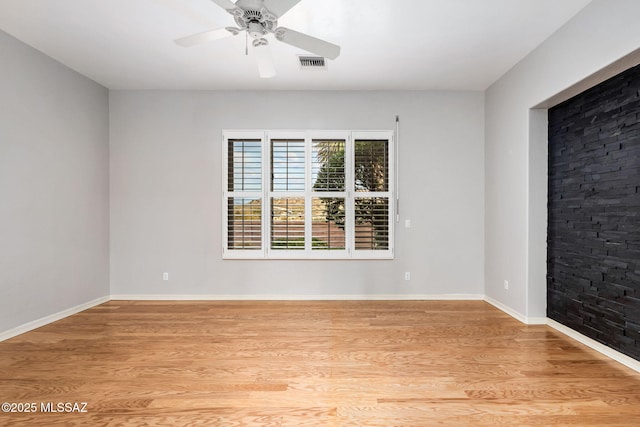 empty room featuring ceiling fan and light hardwood / wood-style flooring