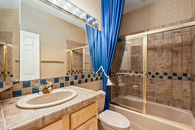 full bathroom featuring vanity, toilet, enclosed tub / shower combo, and tasteful backsplash