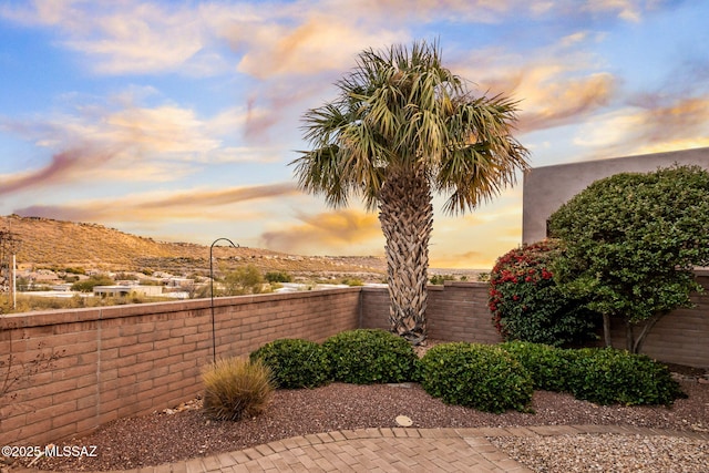 patio terrace at dusk featuring a mountain view