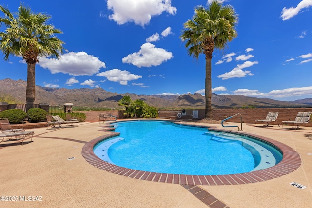 view of pool with a mountain view and a patio area