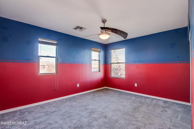 carpeted spare room featuring ceiling fan