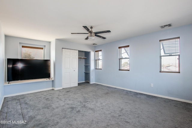 unfurnished bedroom featuring carpet floors, ceiling fan, and a closet