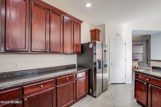 kitchen with stainless steel refrigerator with ice dispenser and dark stone countertops