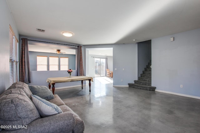 playroom featuring ceiling fan and concrete floors