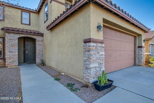 view of exterior entry featuring a garage