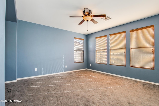 carpeted spare room with ceiling fan