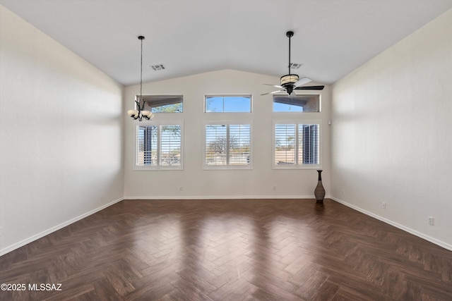 spare room featuring vaulted ceiling, plenty of natural light, ceiling fan with notable chandelier, and dark parquet floors