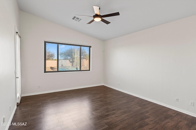 spare room with lofted ceiling, dark hardwood / wood-style floors, and ceiling fan