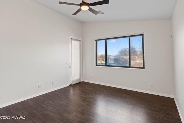 spare room featuring dark wood-type flooring, ceiling fan, and vaulted ceiling