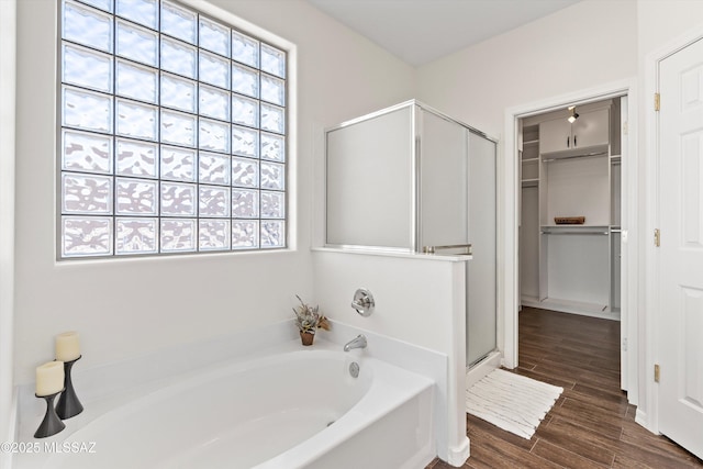 bathroom featuring hardwood / wood-style flooring and independent shower and bath