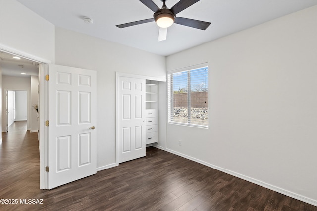 unfurnished bedroom featuring ceiling fan, dark hardwood / wood-style floors, and a closet