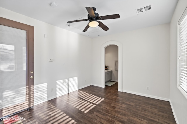 spare room featuring dark hardwood / wood-style floors and ceiling fan