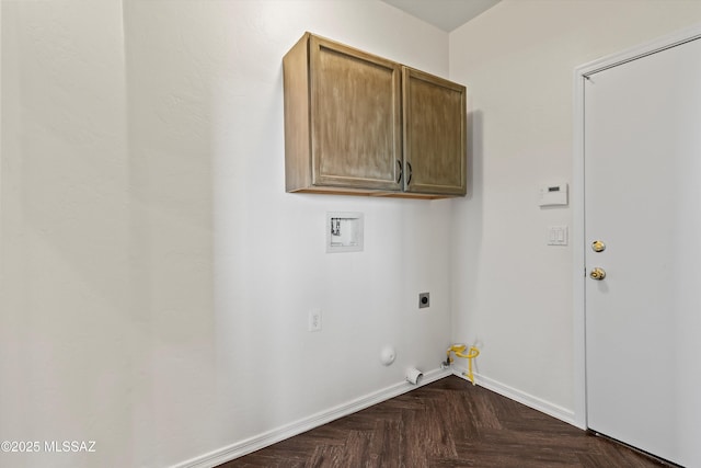 clothes washing area with electric dryer hookup, cabinets, washer hookup, dark parquet floors, and hookup for a gas dryer