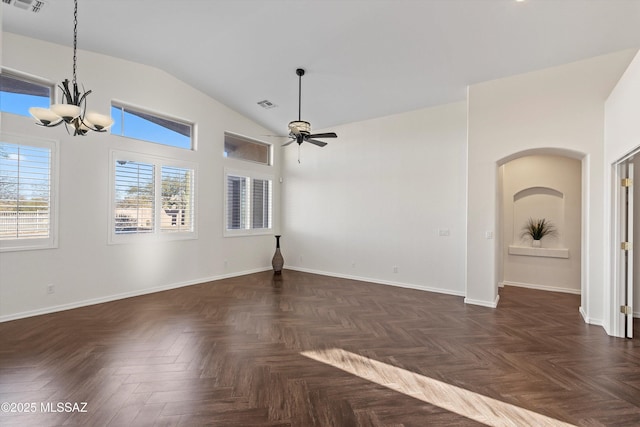 spare room featuring high vaulted ceiling, ceiling fan with notable chandelier, and dark parquet floors