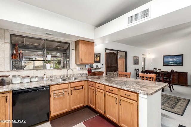 kitchen featuring sink, black dishwasher, light stone counters, and kitchen peninsula