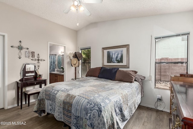 bedroom featuring connected bathroom, ceiling fan, hardwood / wood-style flooring, a textured ceiling, and lofted ceiling