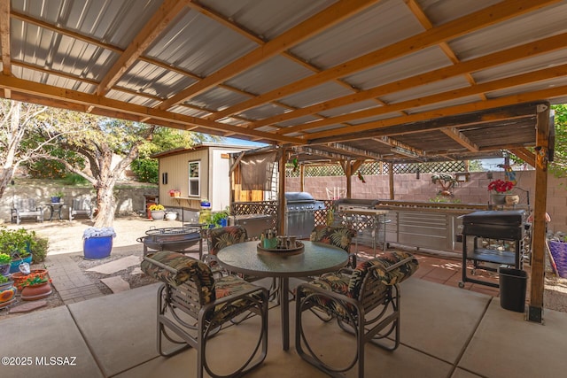 view of patio featuring a grill and an outdoor structure