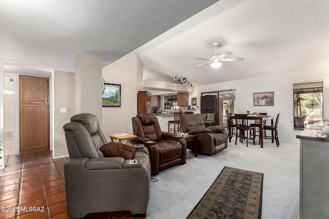 living room featuring carpet flooring, a textured ceiling, ceiling fan, and vaulted ceiling