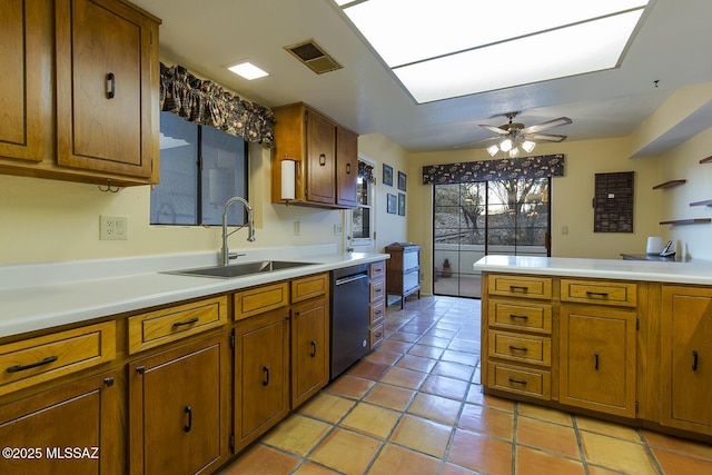 kitchen with sink, stainless steel dishwasher, ceiling fan, light tile patterned floors, and kitchen peninsula