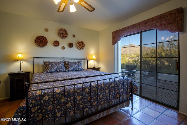 bedroom featuring tile patterned flooring, ceiling fan, and a mountain view