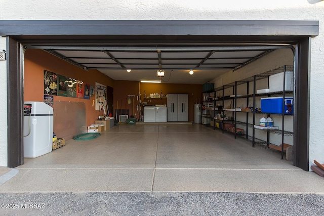 garage with washer / dryer, electric water heater, and a garage door opener